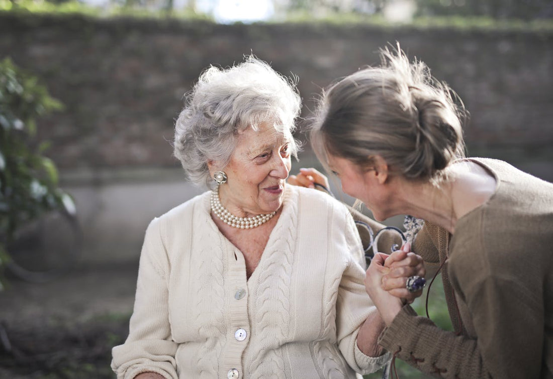 An older woman talking to a younger woman