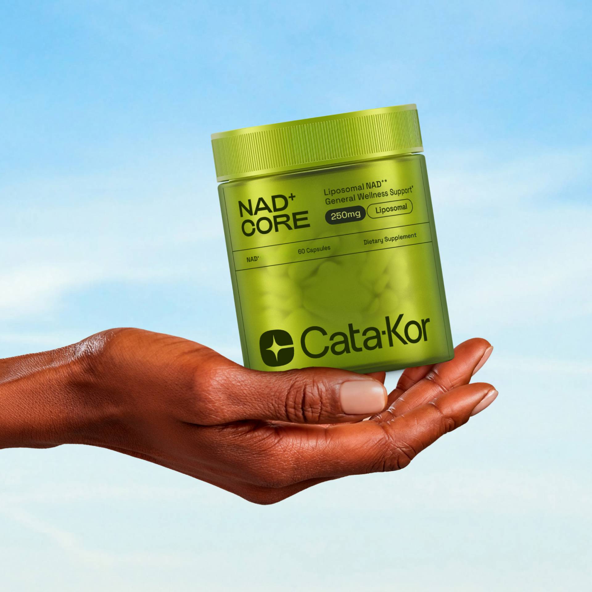 A hand holding the NAD Core supplement