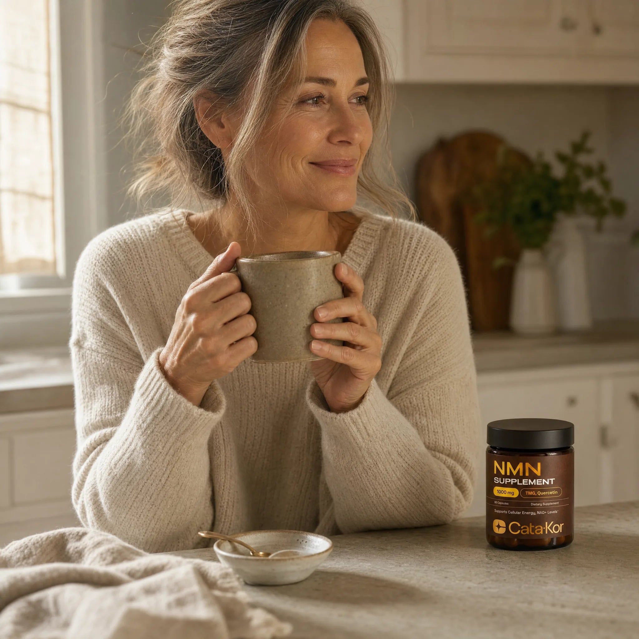 Woman at sunlit kitchen counter with Cata-Kor NMN bottle